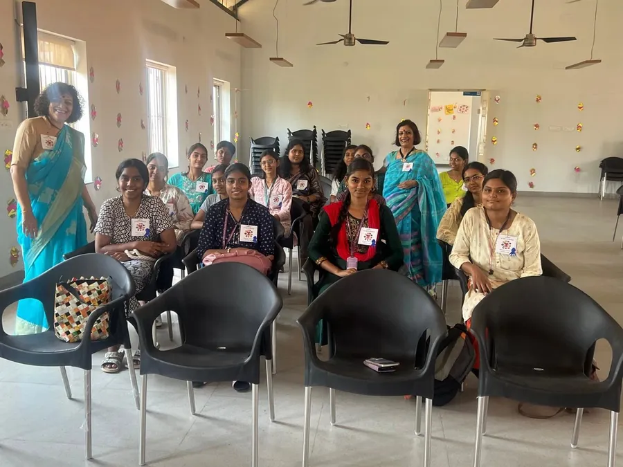 Students seated in a hall with two PRIMAA partners during World Autism Day