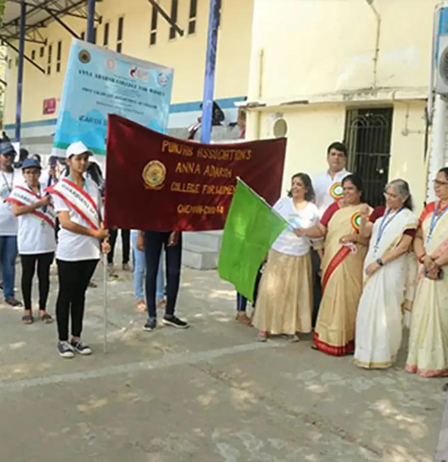 Students and faculty with flags at the Earth Day rally in Anna Nagar